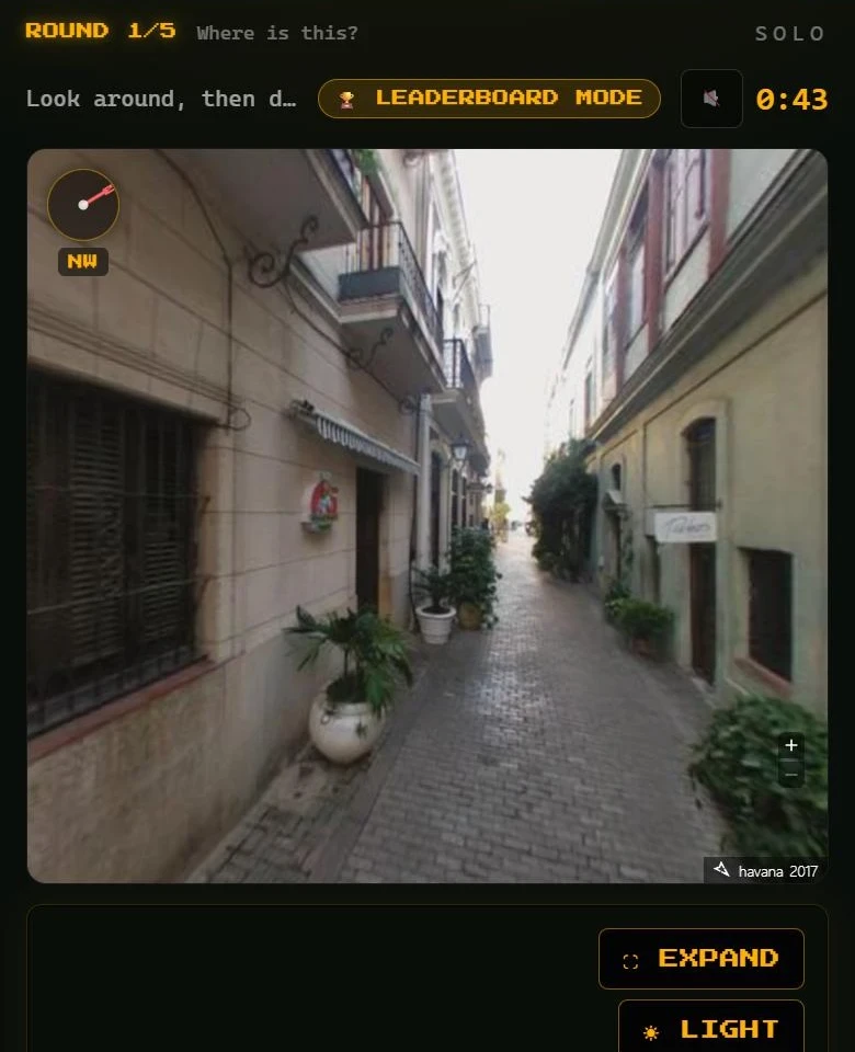 Pin Drop street view of a narrow cobbled street with a countdown timer and a button to expand the view